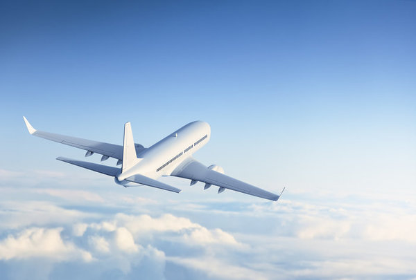 Commercial jet flying above clouds.